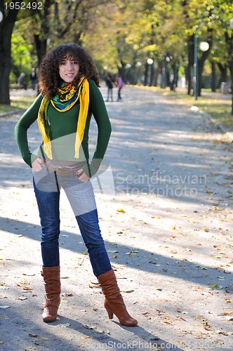 Image of Young curly woman outdoors