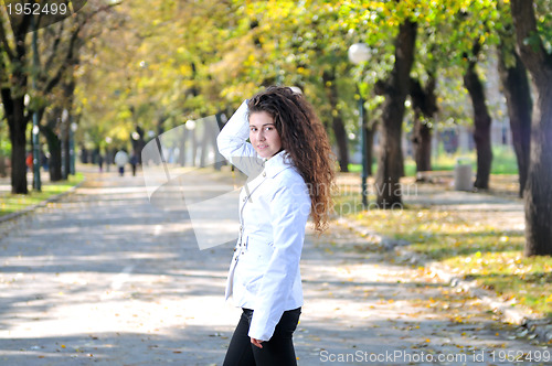Image of brunette Cute young woman smiling outdoors in nature