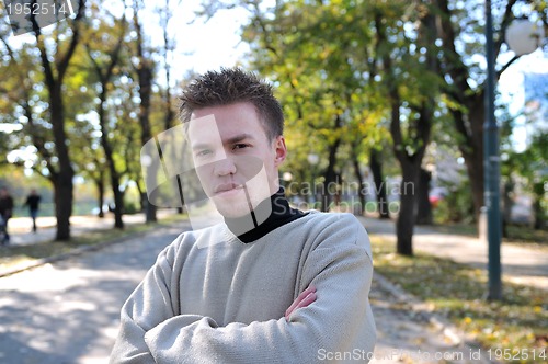 Image of happy young casual man outdoor portrait posing