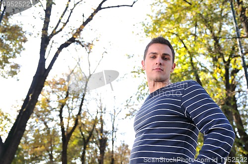 Image of happy young casual man outdoor portrait posing