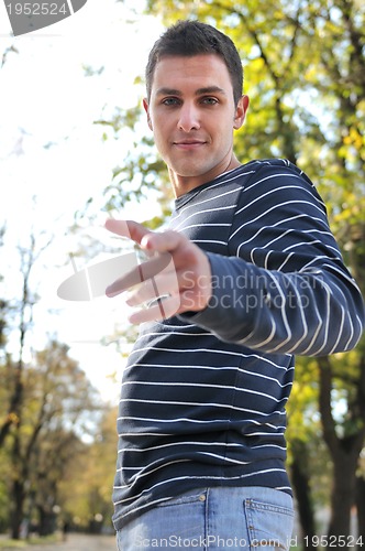 Image of happy young casual man outdoor portrait posing