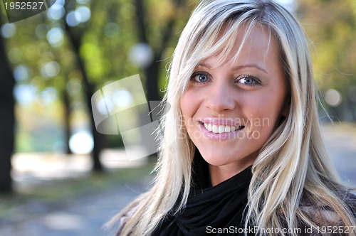 Image of blonde Cute young woman smiling outdoors