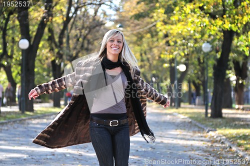 Image of blonde Cute young woman smiling outdoors