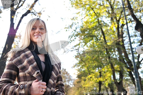 Image of blonde Cute young woman smiling outdoors