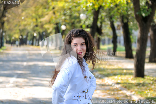 Image of brunette Cute young woman smiling outdoors in nature
