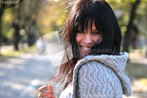 Image of brunette Cute young woman smiling outdoors