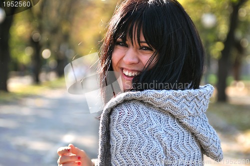 Image of brunette Cute young woman smiling outdoors