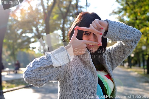 Image of brunette Cute young woman  posing outdoors