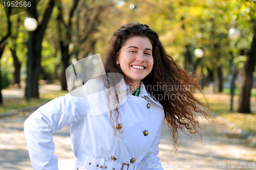 Image of brunette Cute young woman smiling outdoors in nature