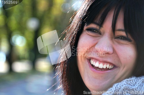 Image of brunette Cute young woman smiling outdoors
