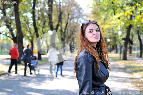 Image of brunette Cute young woman posing outdoors