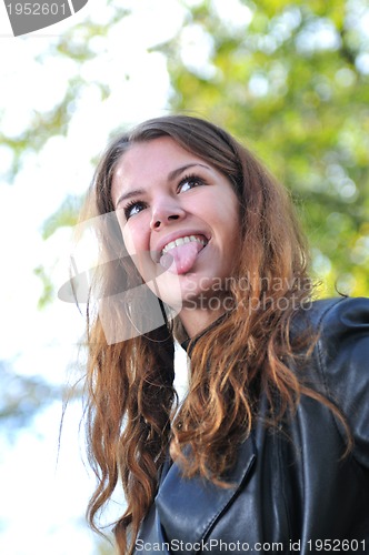 Image of brunette Cute young woman smiling outdoors in nature