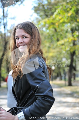 Image of brunette Cute young woman smiling outdoors in nature