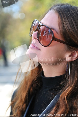 Image of brunette Cute young woman posing outdoors