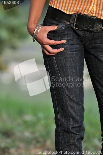 Image of woman torso jeans  stomach outdoor