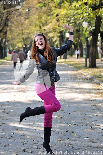 Image of brunette Cute young woman smiling outdoors in nature