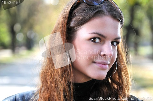 Image of brunette Cute young woman posing outdoors