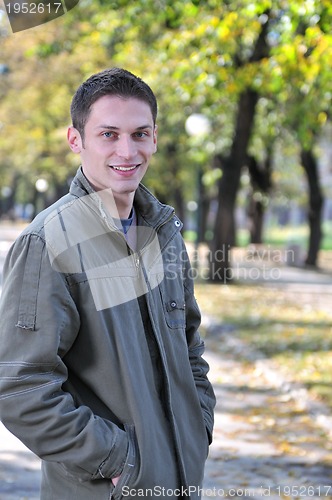 Image of happy young casual man outdoor portrait smiling