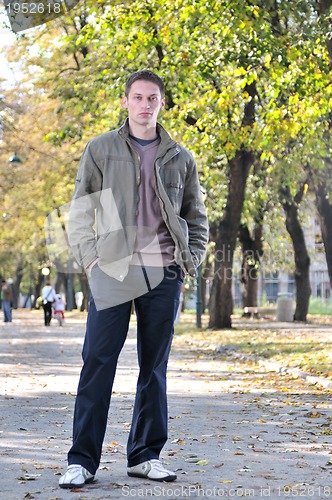 Image of happy young casual man outdoor portrait posing