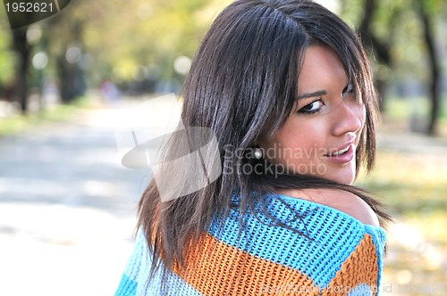 Image of brunette Cute young woman posing outdoors