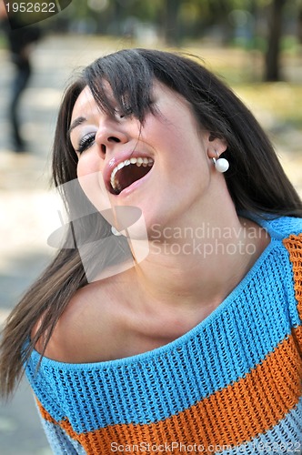 Image of brunette Cute young woman smiling outdoors in nature