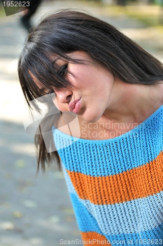 Image of brunette Cute young woman posing outdoors