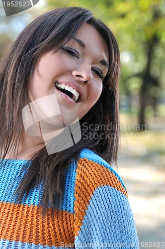 Image of brunette Cute young woman smiling outdoors in nature