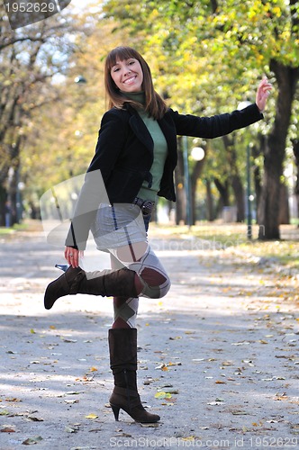 Image of brunette Cute young woman smiling outdoors in nature