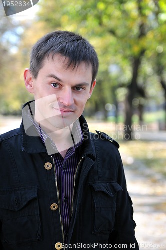 Image of happy young casual man outdoor portrait posing