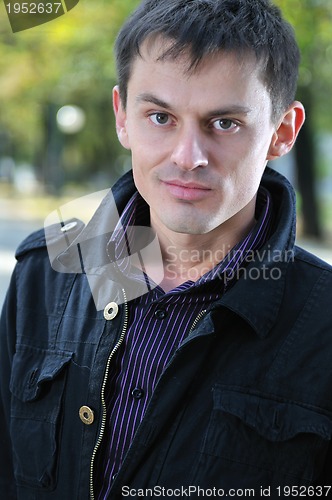 Image of happy young casual man outdoor portrait posing