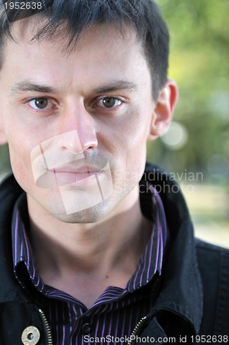 Image of happy young casual man outdoor portrait posing