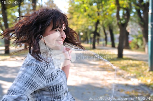 Image of brunette Cute young woman  dancing outdoors