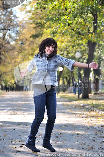 Image of brunette Cute young woman  dancing outdoors