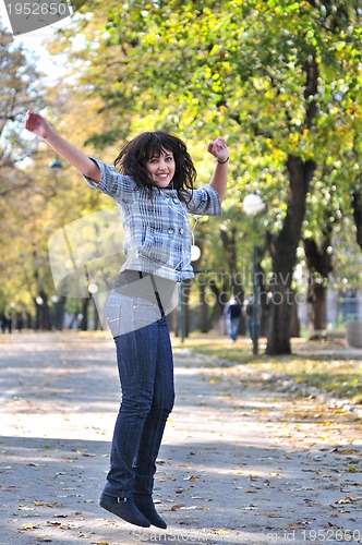 Image of brunette Cute young woman  dancing outdoors