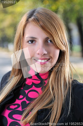 Image of brunette Cute young woman smiling outdoors