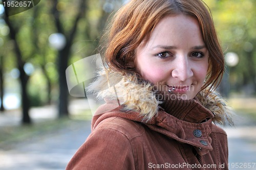 Image of brunette Cute young woman with piercing posing outdoors