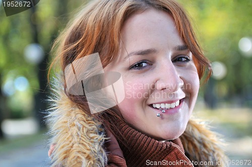 Image of brunette Cute young woman smiling outdoors