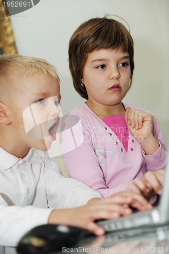 Image of childrens have fun and playing games on laptop computer