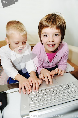 Image of childrens have fun and playing games on laptop computer