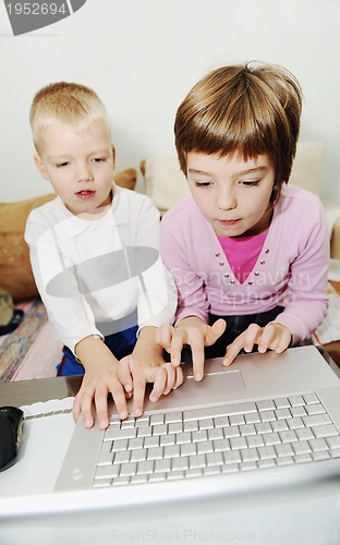 Image of childrens have fun and playing games on laptop computer