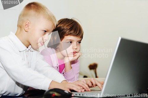 Image of childrens have fun and playing games on laptop computer