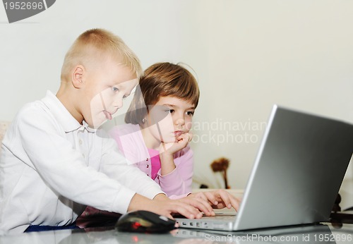 Image of childrens have fun and playing games on laptop computer