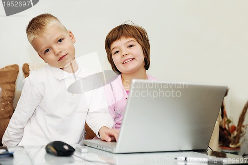 Image of childrens have fun and playing games on laptop computer