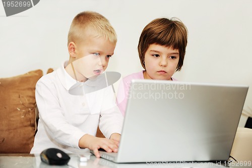 Image of childrens have fun and playing games on laptop computer