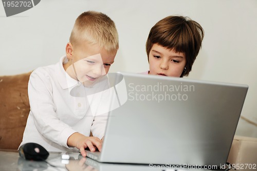 Image of childrens have fun and playing games on laptop computer