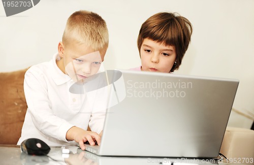 Image of childrens have fun and playing games on laptop computer