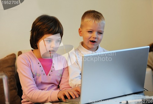 Image of childrens have fun and playing games on laptop computer