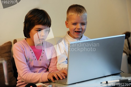 Image of childrens have fun and playing games on laptop computer