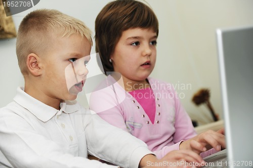 Image of childrens have fun and playing games on laptop computer