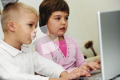 Image of childrens have fun and playing games on laptop computer